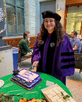 graduating student cutting cake